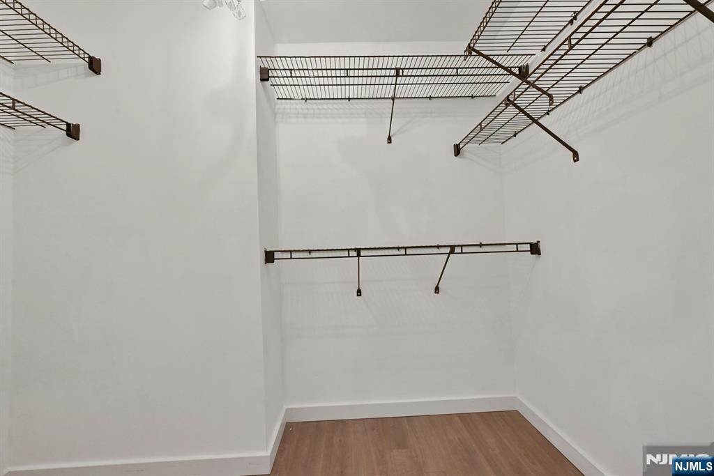 245 Prospect Avenue, Unit 12B Hackensack, NJ 07601 - Photo 18 of 33 a view of a room with racks on the wall