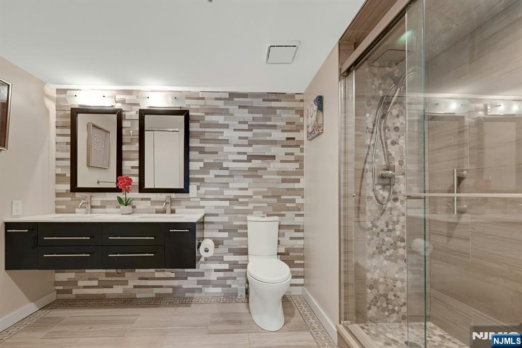 245 Prospect Avenue, Unit 12B Hackensack, NJ 07601 - Photo 19 of 33 a bathroom with a sink and a mirror