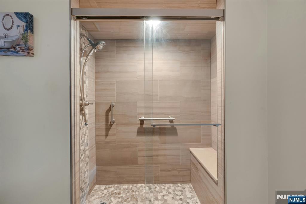245 Prospect Avenue, Unit 12B Hackensack, NJ 07601 - Photo 20 of 33 a bathroom with a glass shower door