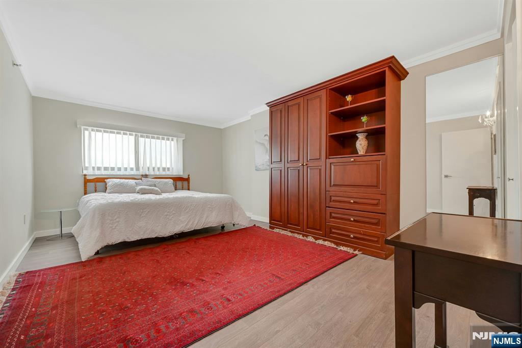 245 Prospect Avenue, Unit 12B Hackensack, NJ 07601 - Photo 21 of 33 a bedroom with a bed and a table in it