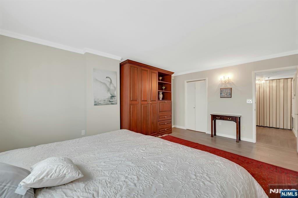 245 Prospect Avenue, Unit 12B Hackensack, NJ 07601 - Photo 22 of 33 a bedroom with a bed and a window