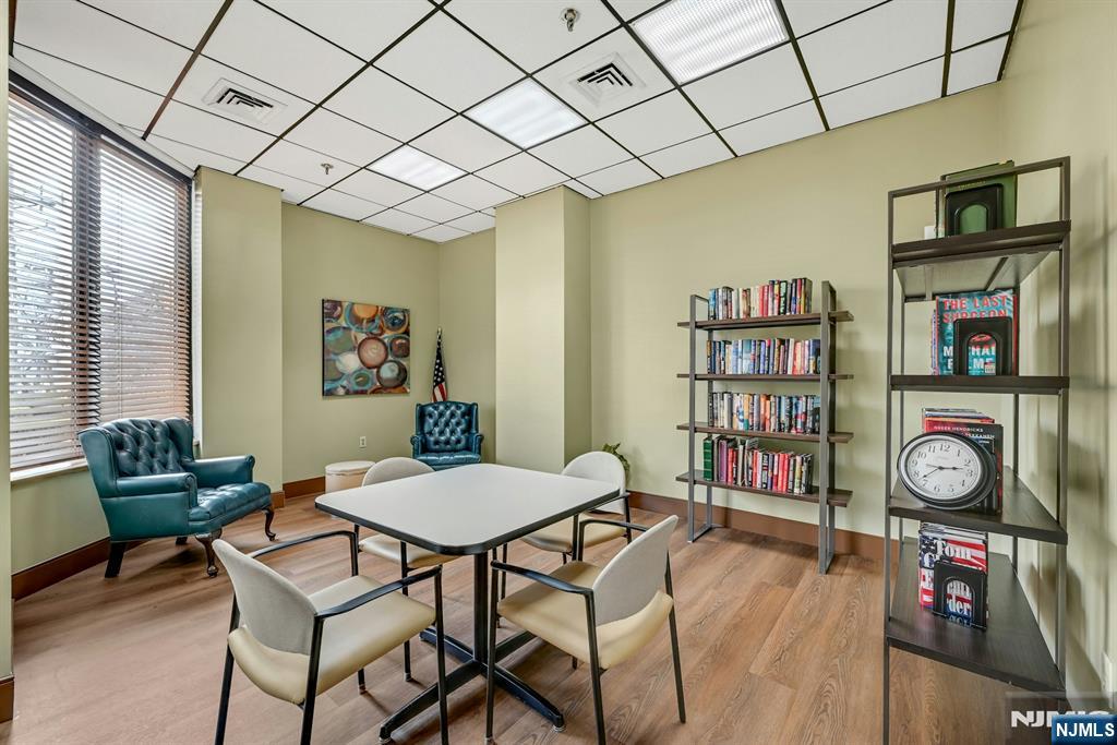 245 Prospect Avenue, Unit 12B Hackensack, NJ 07601 - Photo 27 of 33 a view of a dining room with furniture and a book shelf
