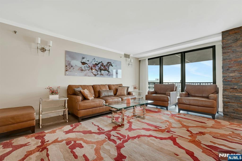 245 Prospect Avenue, Unit 12B Hackensack, NJ 07601 - Photo 6 of 33 a living room with furniture a large window and a rug