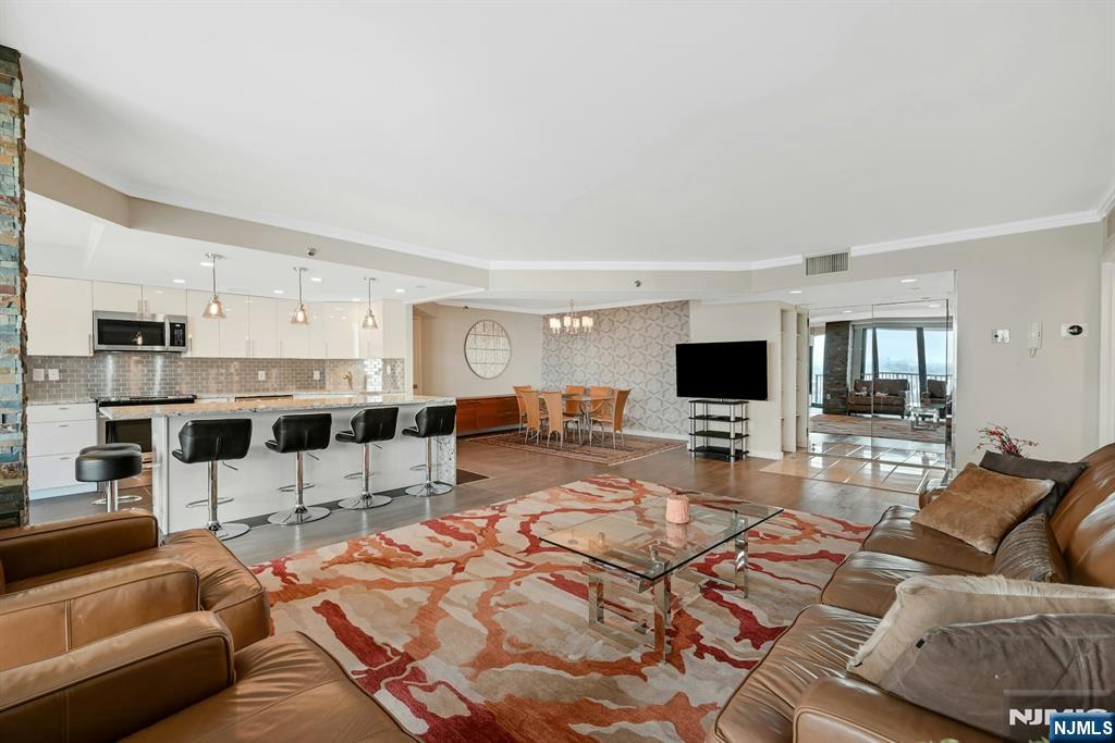 245 Prospect Avenue, Unit 12B Hackensack, NJ 07601 - Photo 8 of 33 a living room with furniture and a flat screen tv