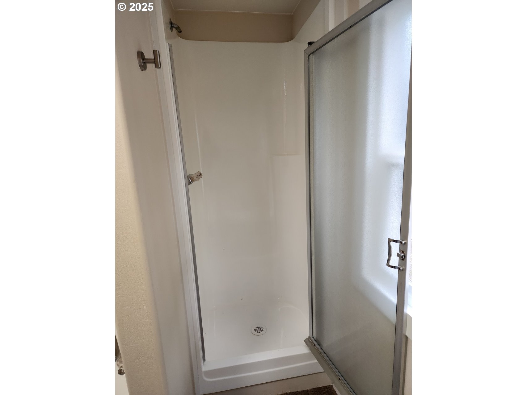 6310 Highway 101, Unit 16 Otis, OR 97368 - Photo 14 of 21 a bathroom with a glass shower door