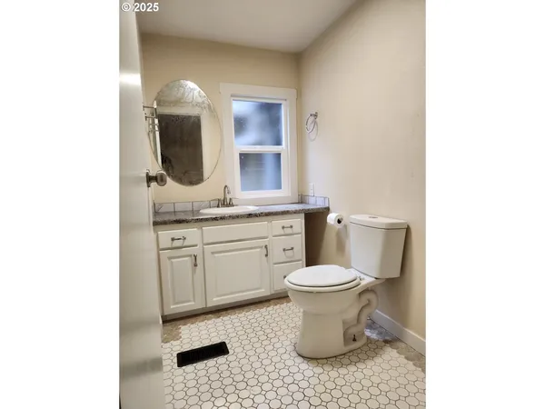 a bathroom with a sink toilet and mirror