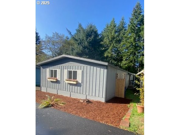 6310 Highway 101, Unit 16 Otis, OR 97368 - Photo 18 of 21 a backyard of a house with a tree