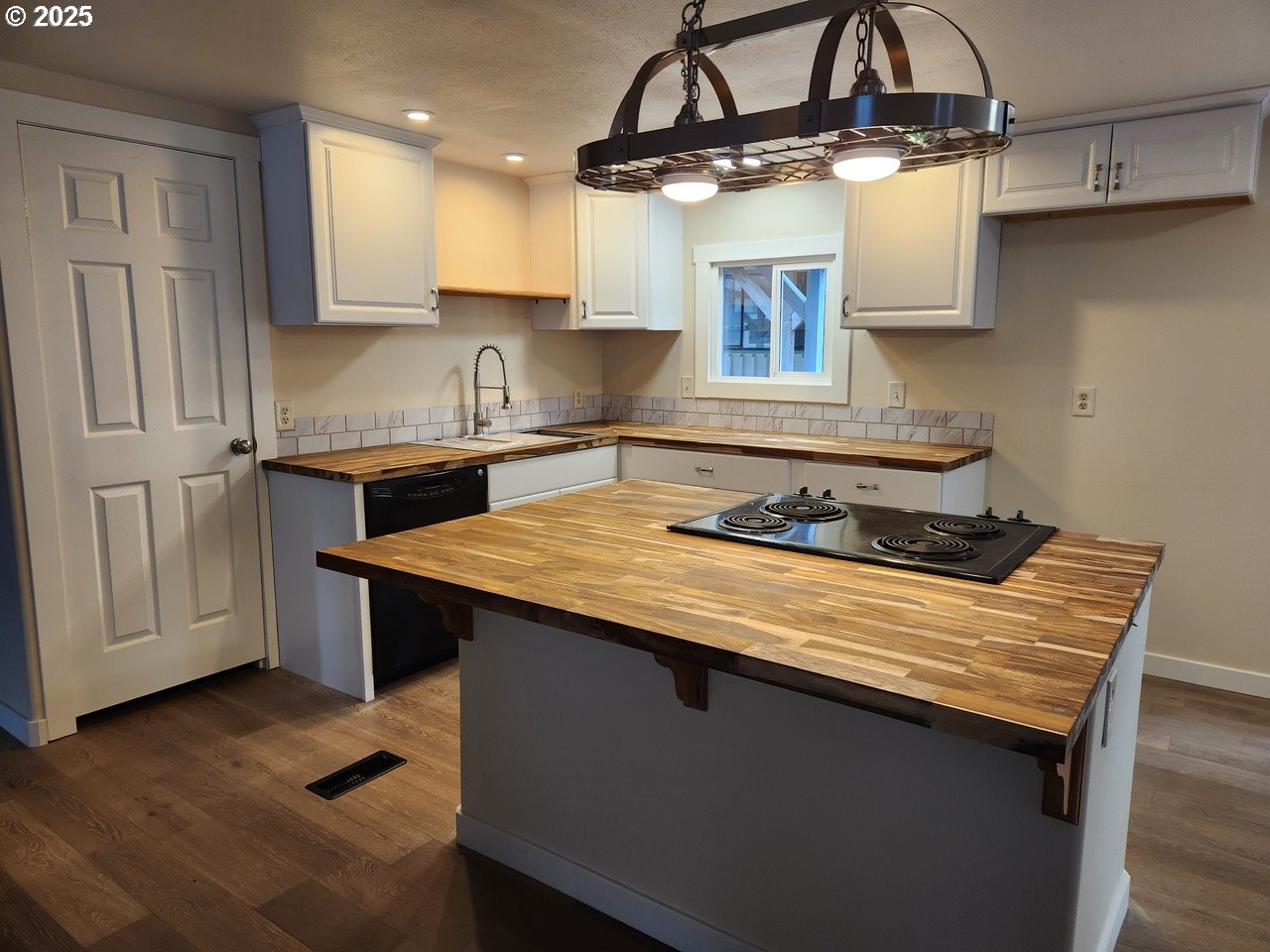 6310 Highway 101, Unit 16 Otis, OR 97368 - Photo 3 of 21 a kitchen with stainless steel appliances granite countertop a sink stove and refrigerator