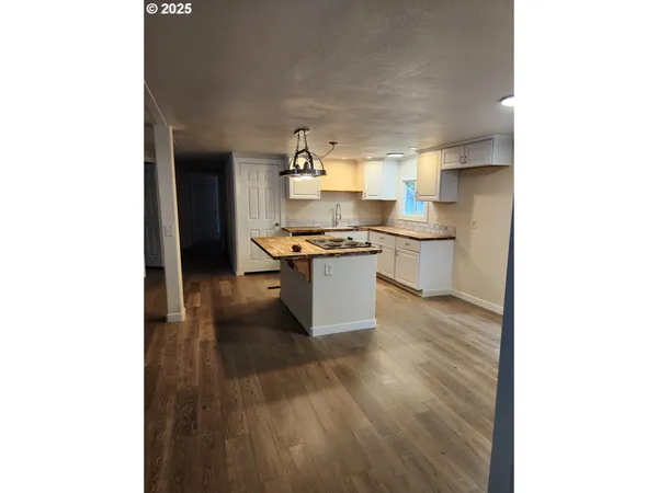 a kitchen with a sink and a stove top oven