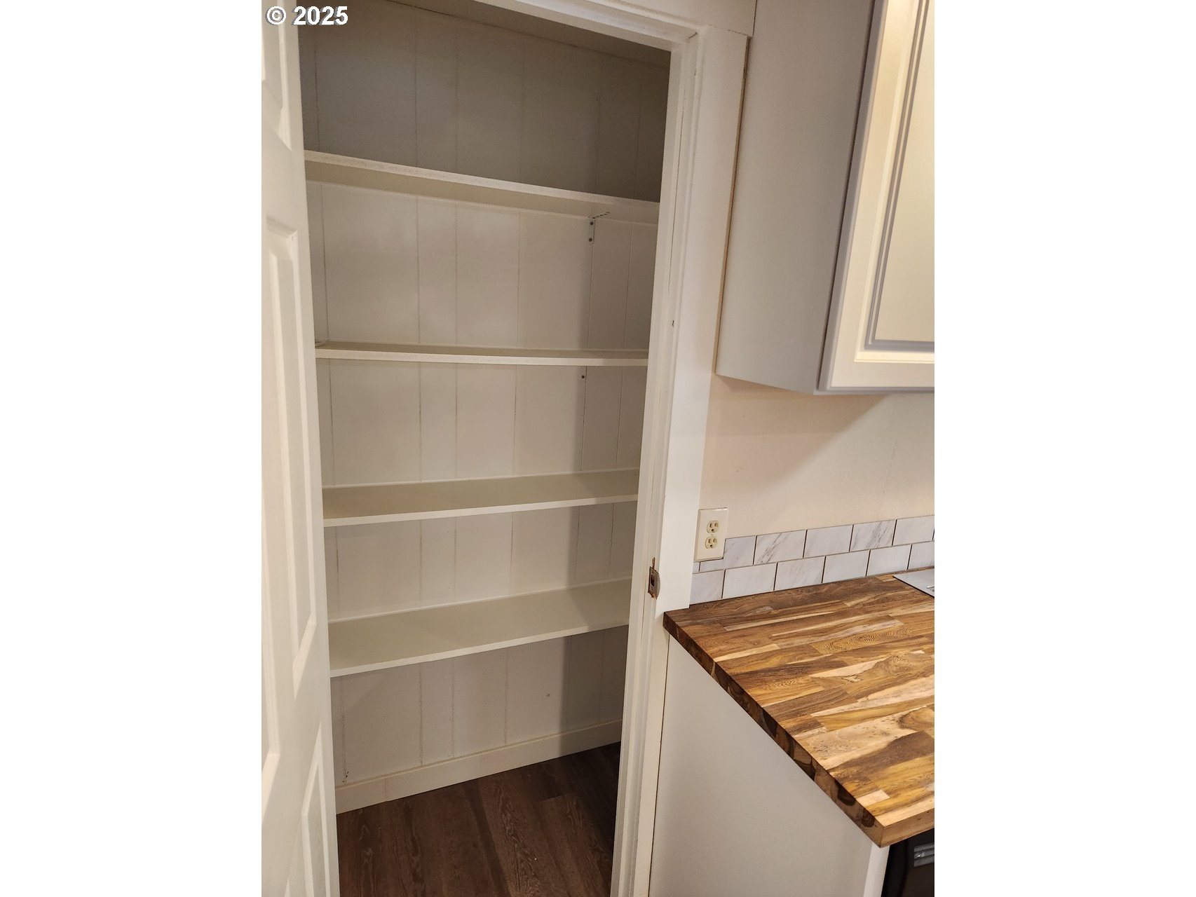 6310 Highway 101, Unit 16 Otis, OR 97368 - Photo 7 of 21 a view of a kitchen with white cabinets and a window