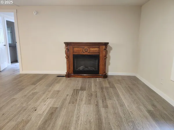 a view of an empty room and wooden floor