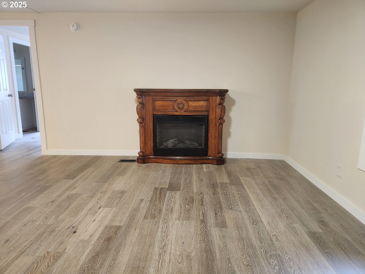 6310 Highway 101, Unit 16 Otis, OR 97368 - Photo 9 of 21 a view of an empty room and wooden floor