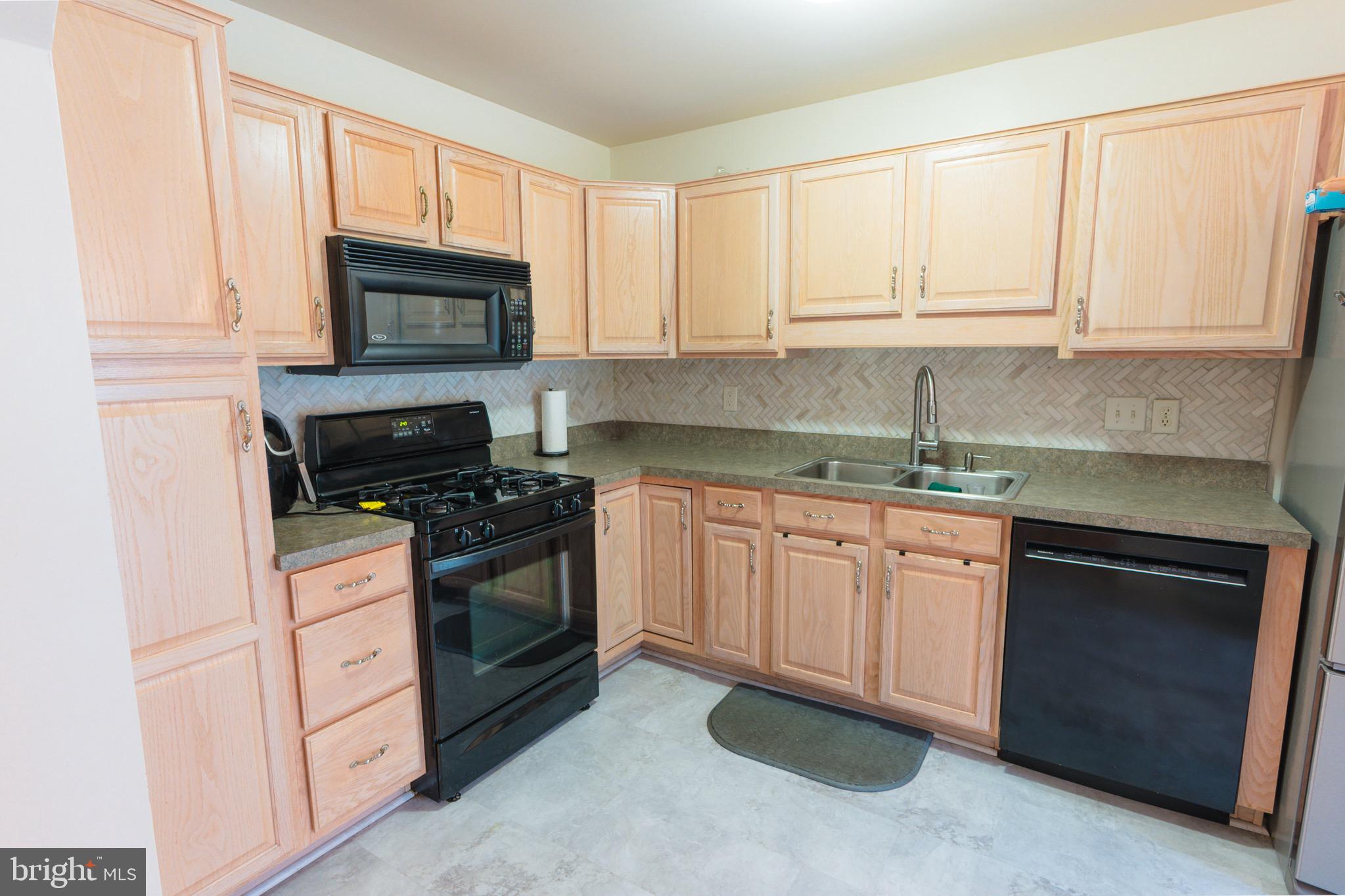 21 White Pine Gulch Reading, PA 19607 - Photo 11 of 35 a kitchen with white cabinets appliances and a window
