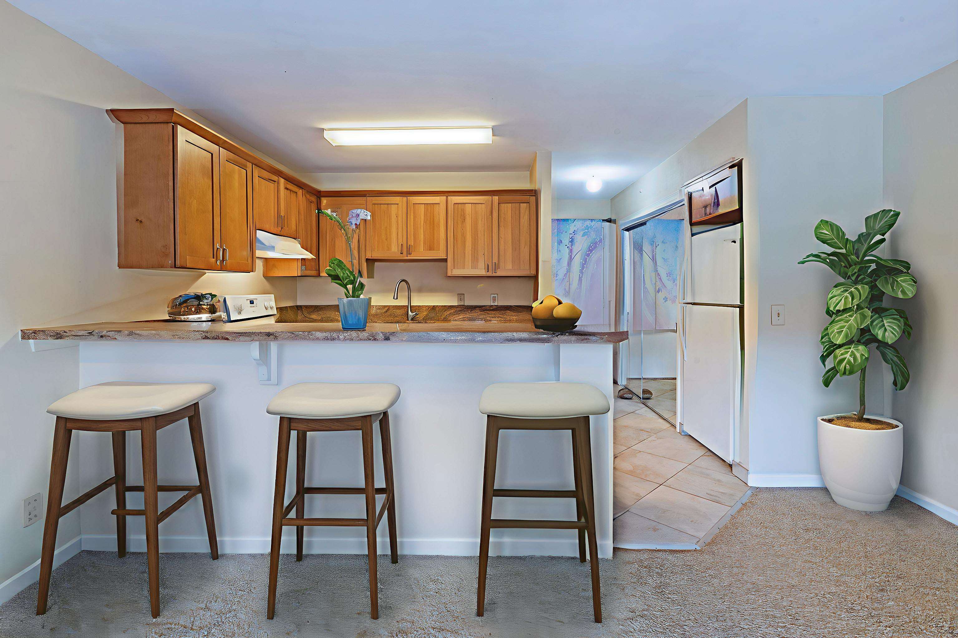 3740 Lower Honoapiilani Road, Unit D305 Lahaina, HI 96761 - Photo 15 of 32 a kitchen with a table and chairs
