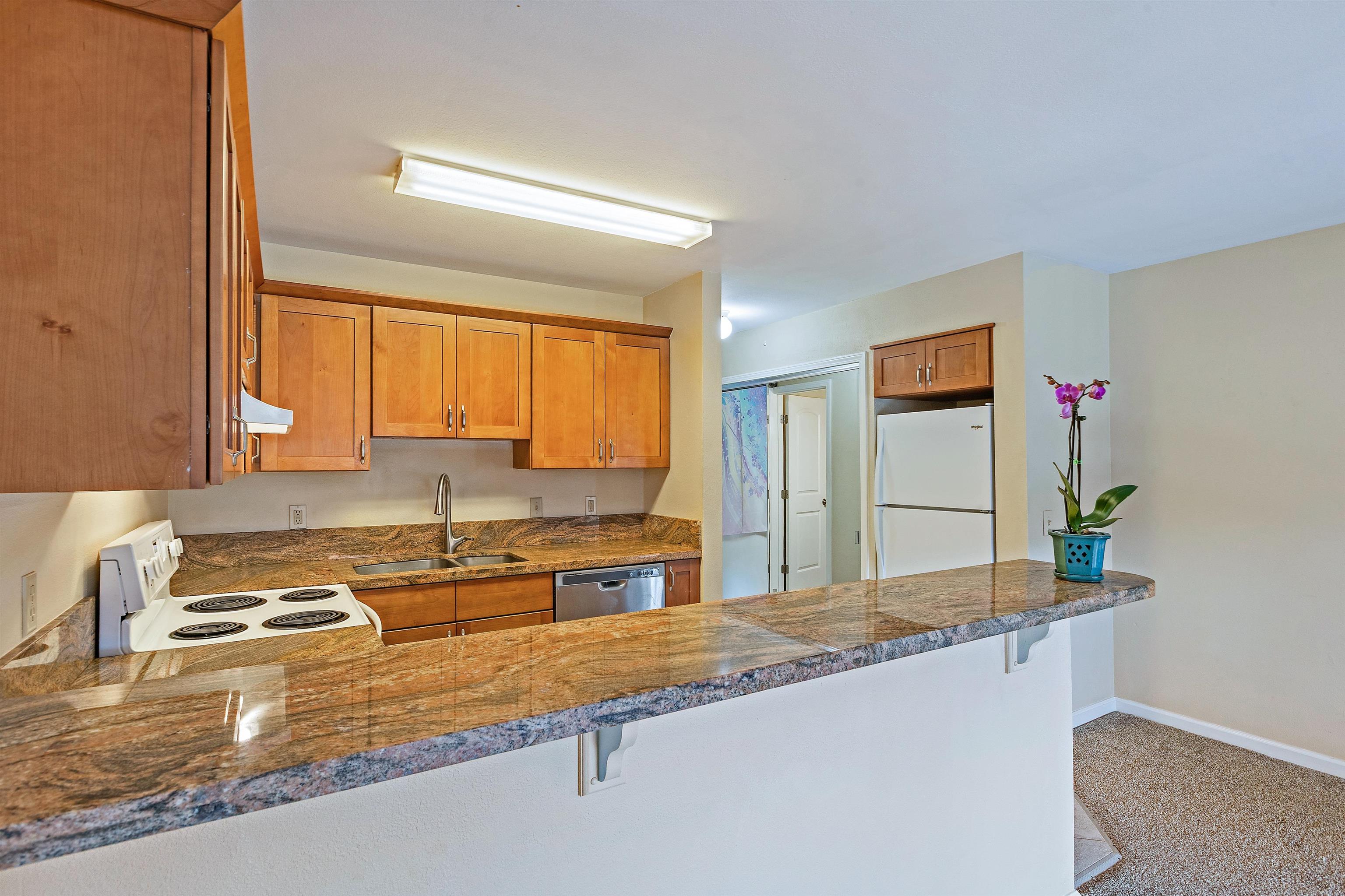 3740 Lower Honoapiilani Road, Unit D305 Lahaina, HI 96761 - Photo 2 of 32 a kitchen with granite countertop a sink and a stove