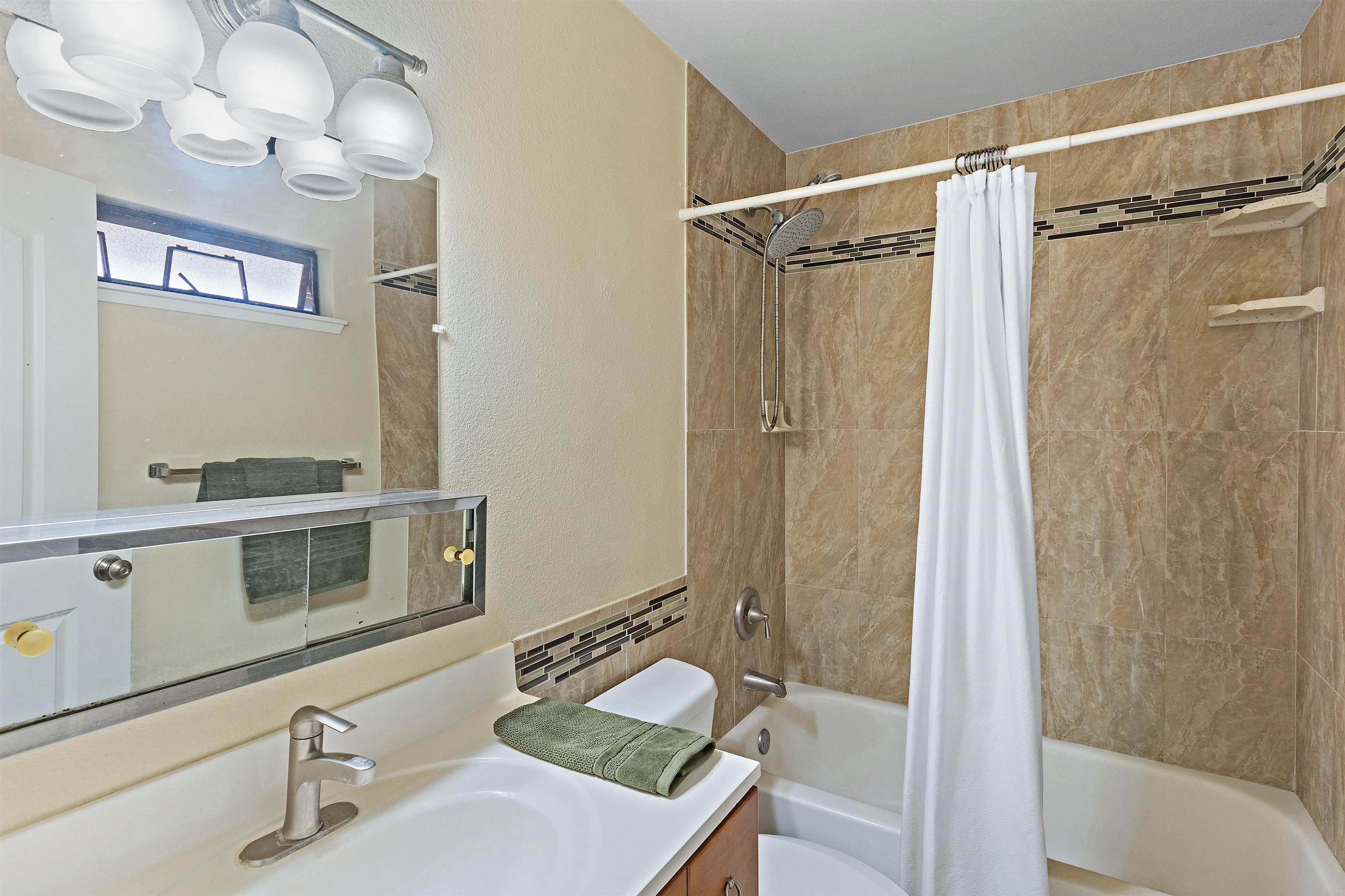 3740 Lower Honoapiilani Road, Unit D305 Lahaina, HI 96761 - Photo 24 of 32 a bathroom with a sink and a mirror