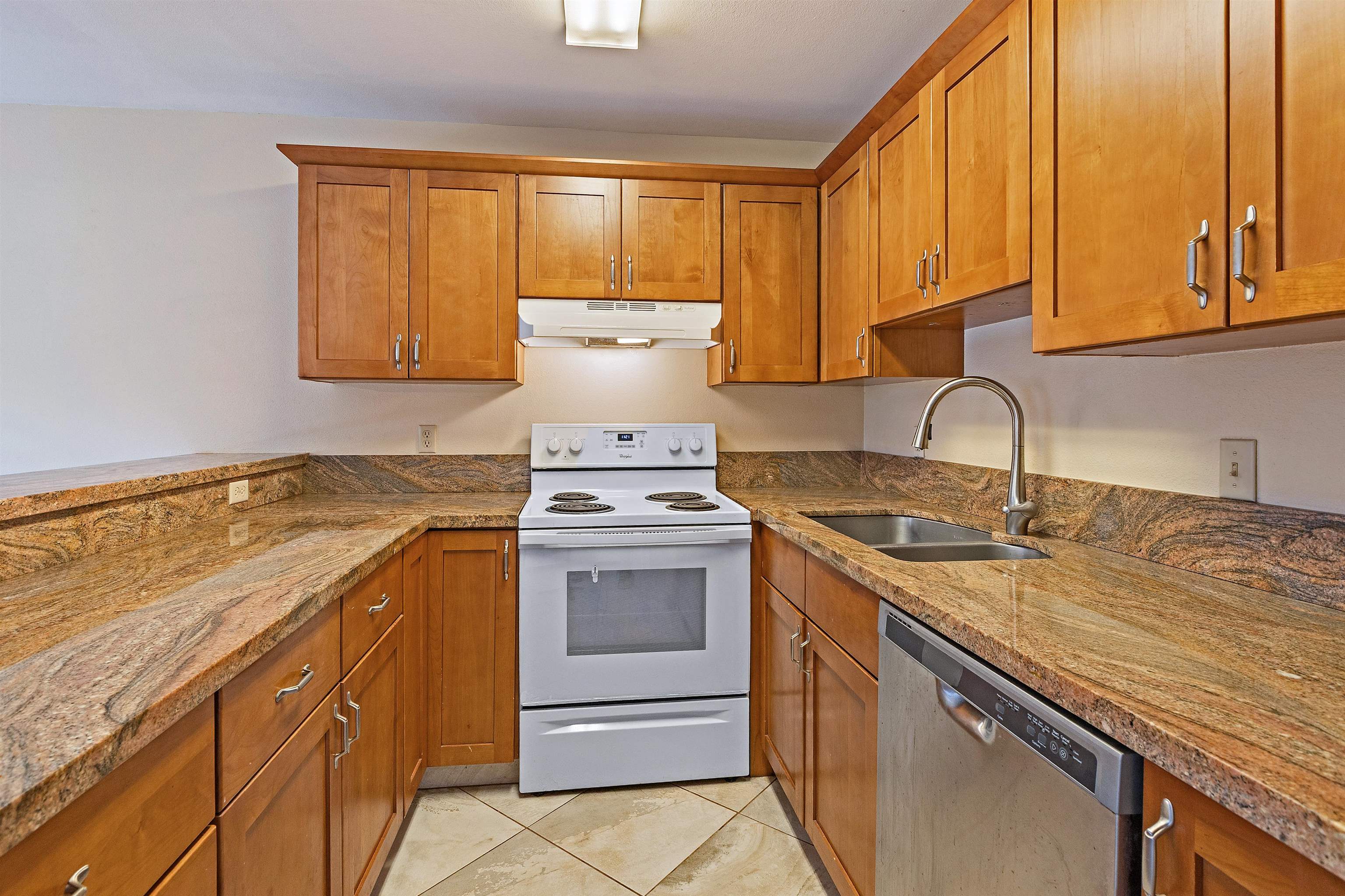 3740 Lower Honoapiilani Road, Unit D305 Lahaina, HI 96761 - Photo 4 of 32 a kitchen with a sink stove and cabinets