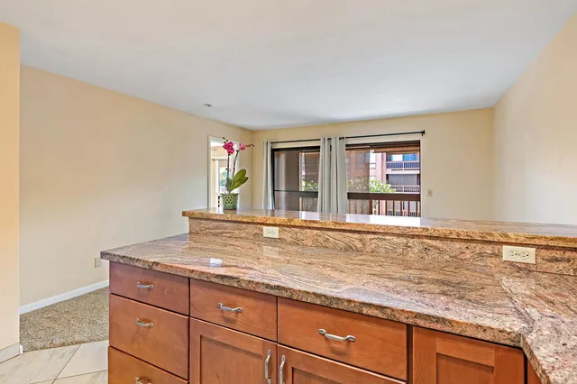 a living room with granite countertop a couch and dresser