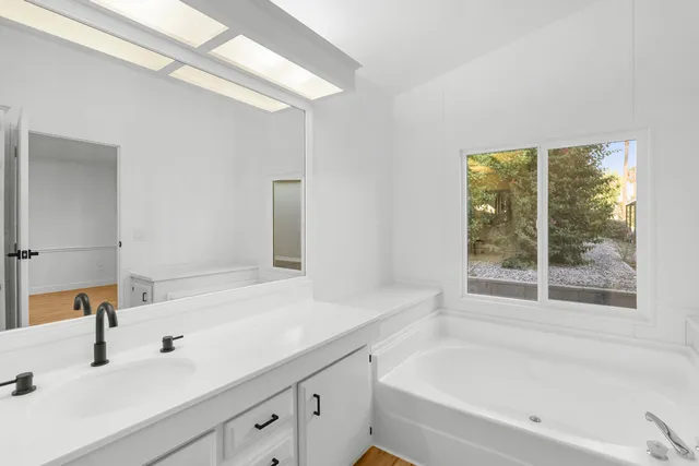 a bathroom with a bathtub and a sink