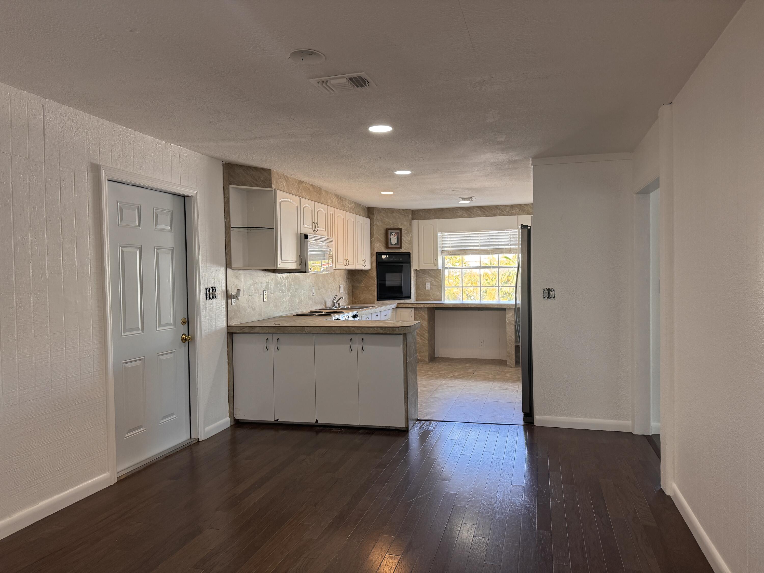 969 Plantation Road Key Largo, FL 33037 - Photo 3 of 26 a kitchen with a refrigerator and a stove top oven