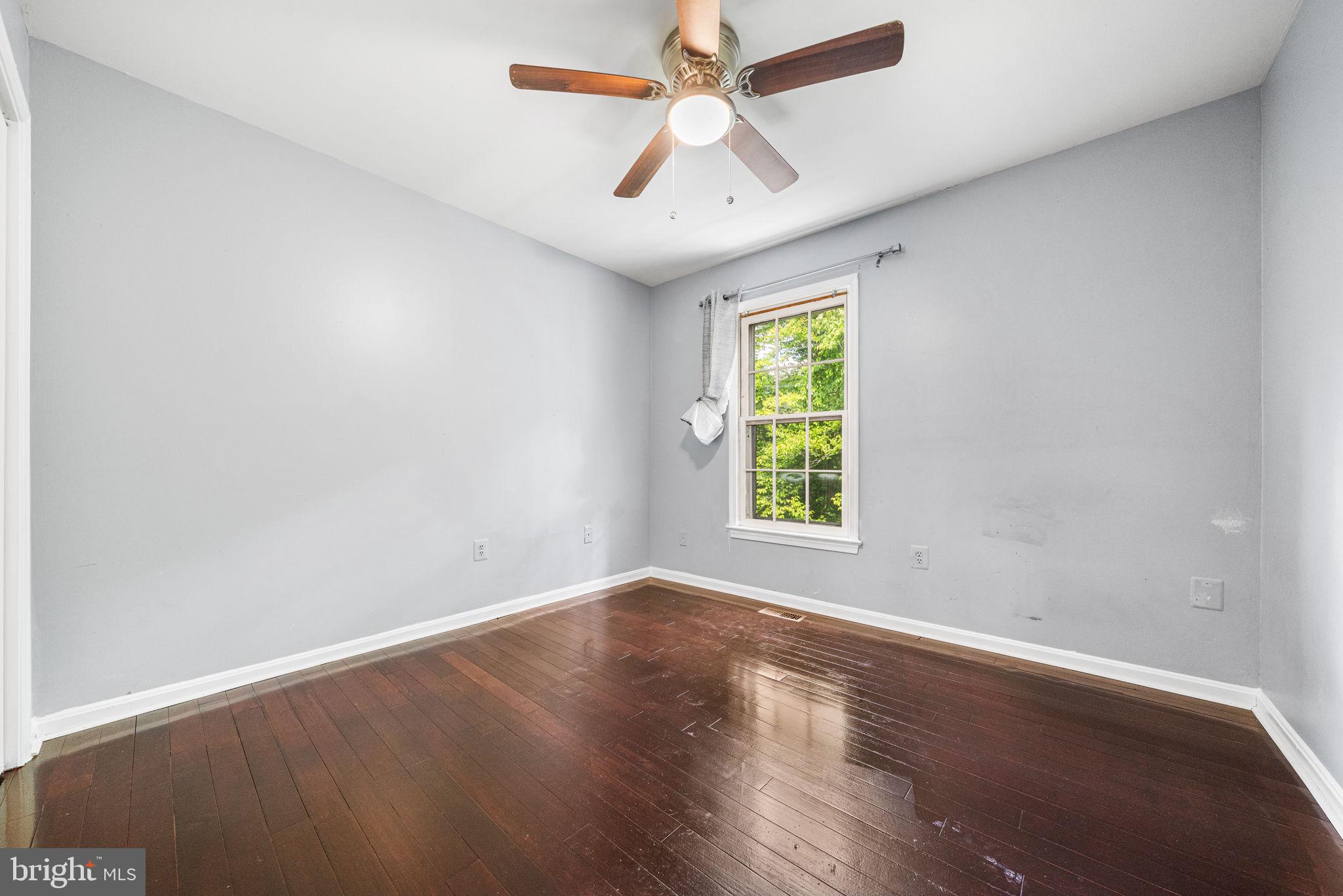 7403 Ridge Oak Court Springfield, VA 22153 - Photo 31 of 54 an empty room with a window and a ceiling fan