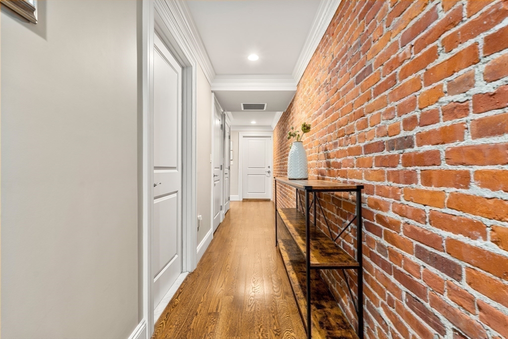 1471 Beacon Street, Unit 5 Brookline, MA 02446 - Photo 18 of 28 a view of a hallway with wooden floor and staircase