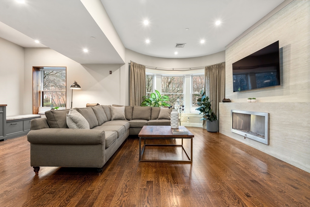 1471 Beacon Street, Unit 5 Brookline, MA 02446 - Photo 2 of 28 a living room with fireplace furniture and a flat screen tv