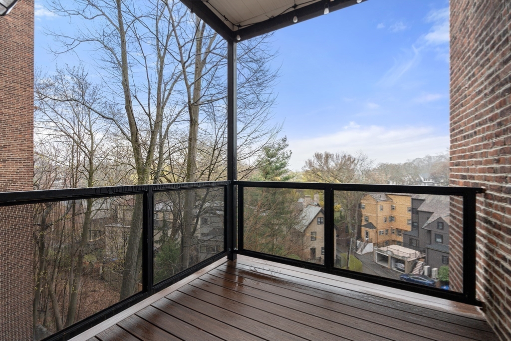 1471 Beacon Street, Unit 5 Brookline, MA 02446 - Photo 27 of 28 a view of a balcony with wooden floor and fence