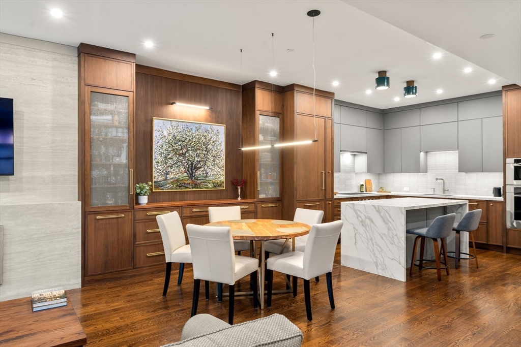 1471 Beacon Street, Unit 5 Brookline, MA 02446 - Photo 6 of 28 a dining room with stainless steel appliances kitchen island granite countertop a dining table chairs and granite counter tops