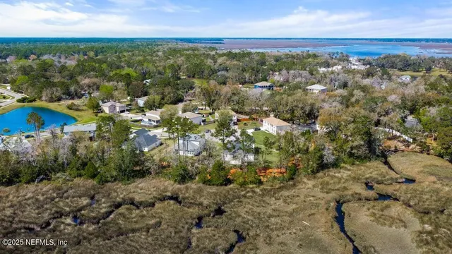 a bathroom with a double vanity sink bathtub and next to a window
