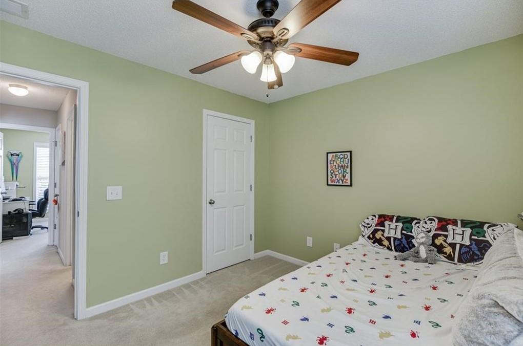 1281 Key Manor Lane Lawrenceville, GA 30045 - Photo 16 of 22 a bedroom with a bed and a chandelier