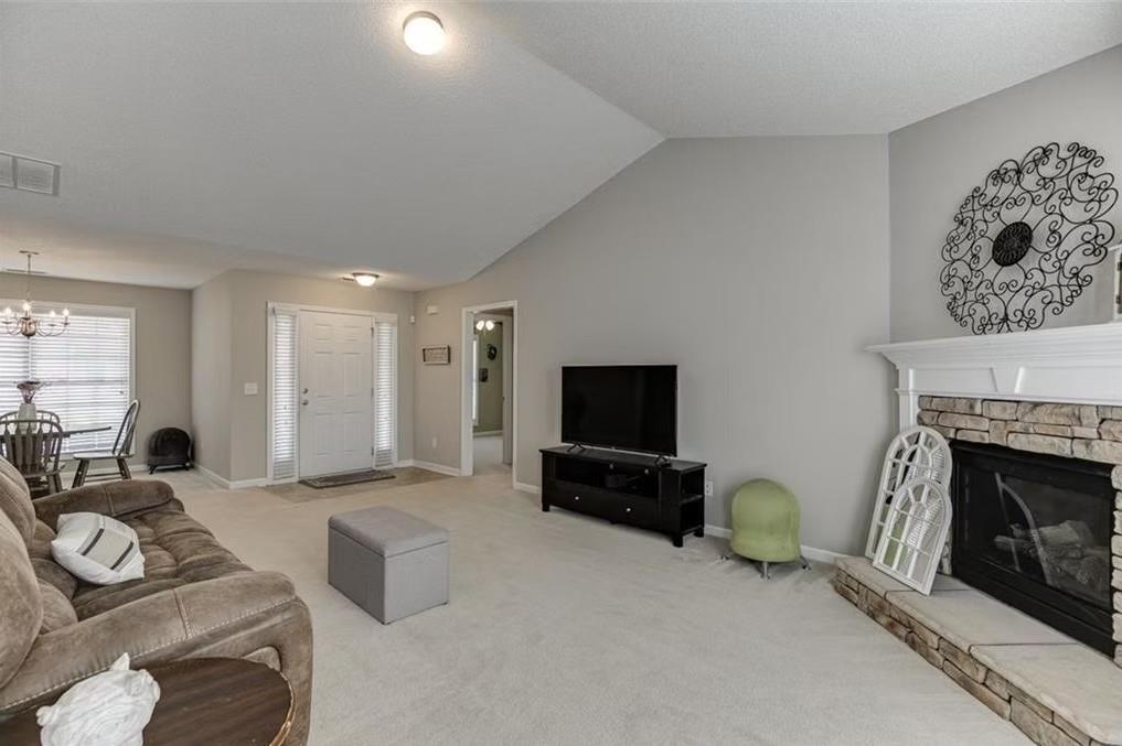 1281 Key Manor Lane Lawrenceville, GA 30045 - Photo 2 of 22 a living room with furniture a flat screen tv and a fireplace