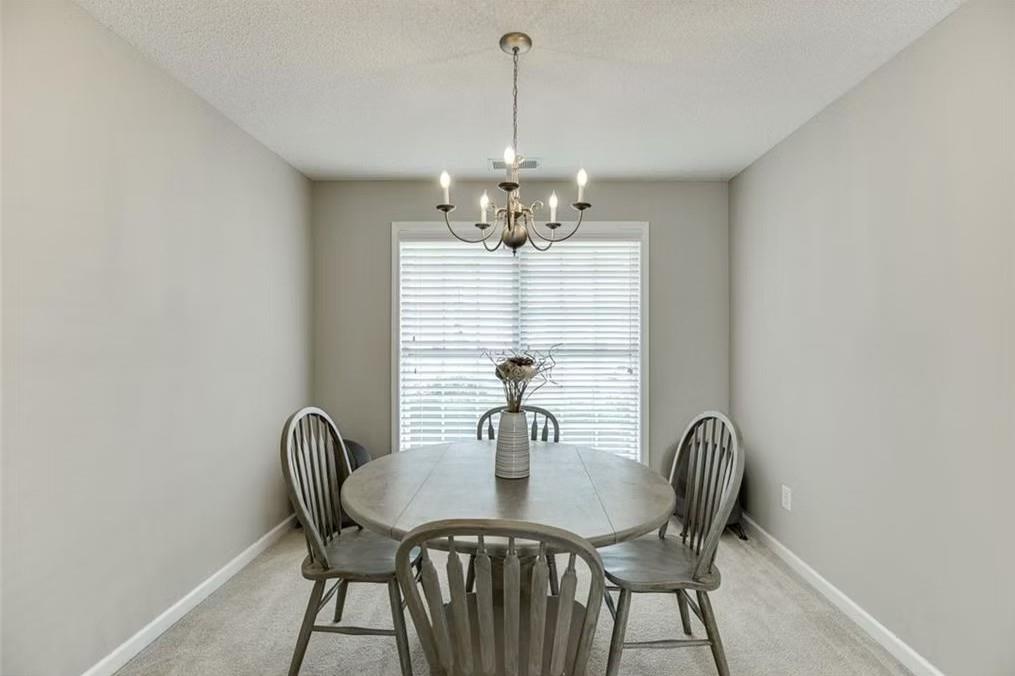 1281 Key Manor Lane Lawrenceville, GA 30045 - Photo 5 of 22 a view of a dining room with furniture and window