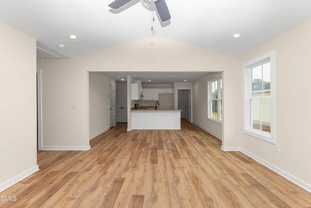a view of a room with wooden floor and window