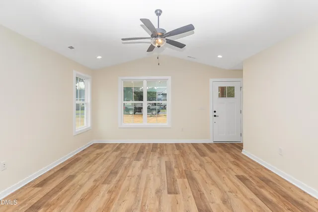 wooden floor in an empty room with a window