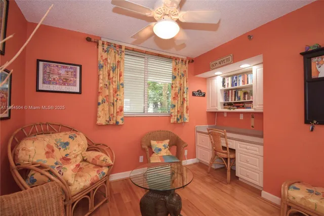 a large kitchen with a wooden floor and cabinets