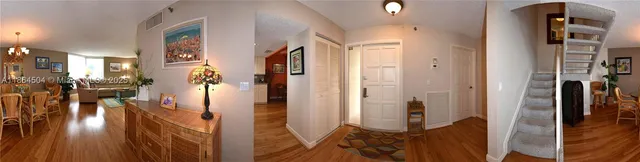 a view of a livingroom with furniture wooden floor and windows