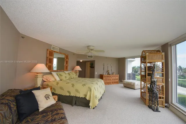 a bed room with a bed and a large window