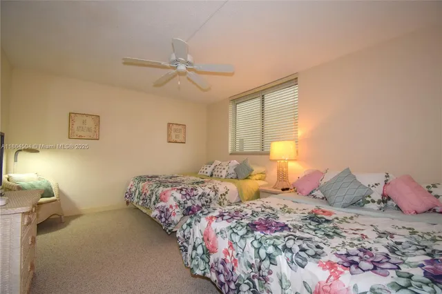 a bedroom with two beds and a window