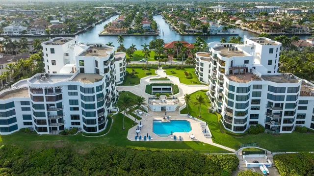 an aerial view of a house with a yard table and chairs