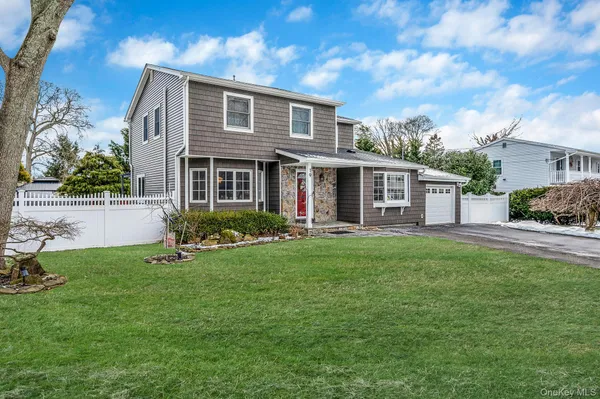 a front view of house with yard and green space