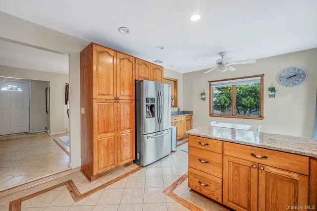 a kitchen with stainless steel appliances granite countertop a refrigerator and a sink