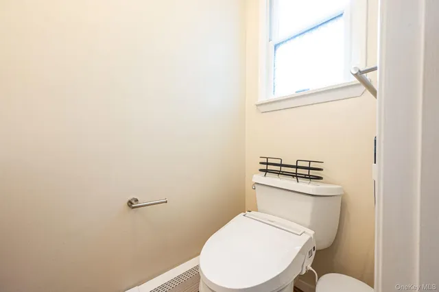 a white toilet sitting next to a bathroom sink