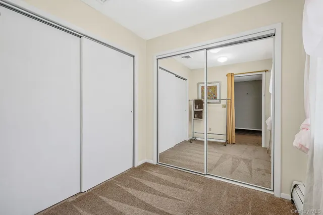a view of a room with a glass door and wooden floor