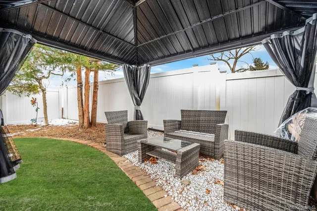 a backyard of a house with table and chairs