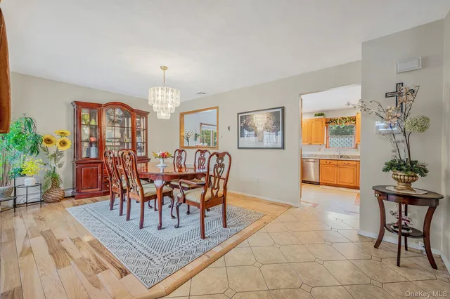 a view of a dining room with furniture and a potted plant