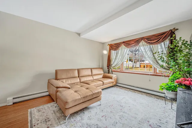 a living room with furniture and flowers