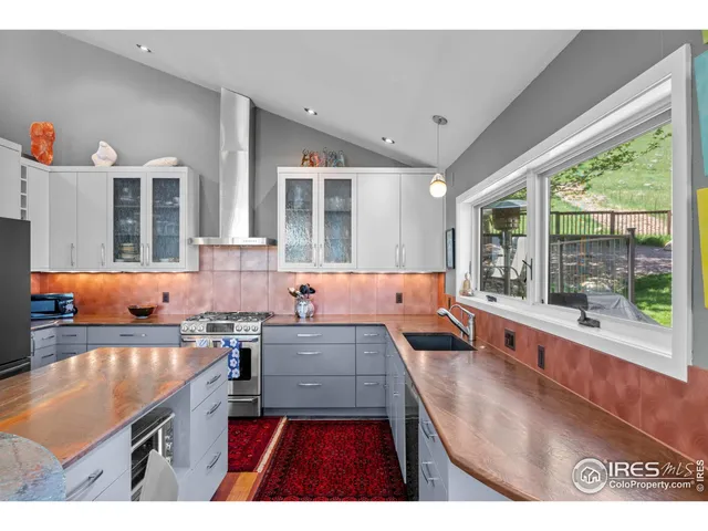 a open kitchen with granite countertop a sink stove and cabinets