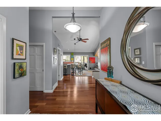 a view of a dining room with furniture a chandelier and wooden floor