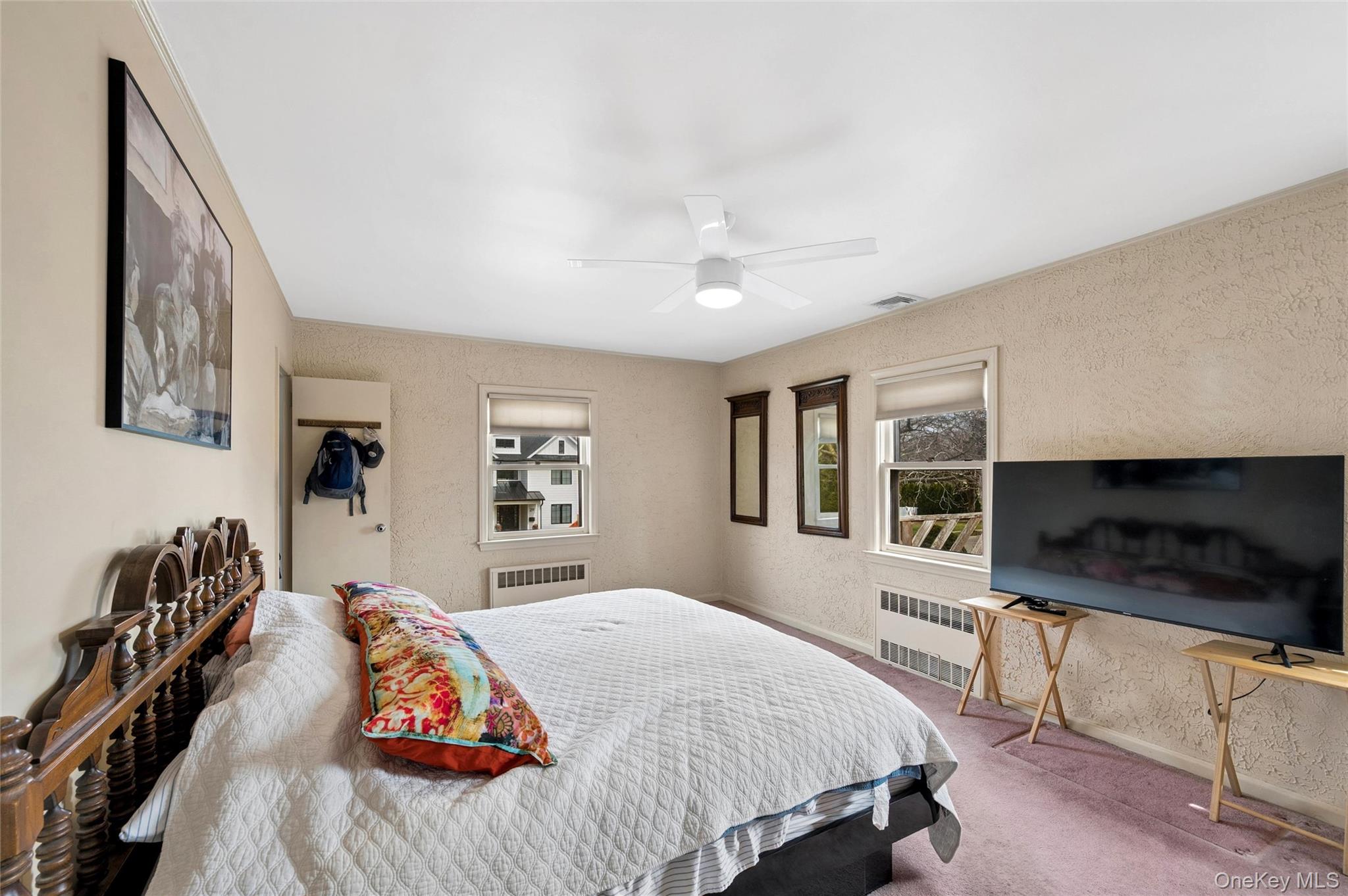 24 Allen Road Rockville Centre, NY 11570 - Photo 22 of 46 a bedroom with a bed and a flat screen tv